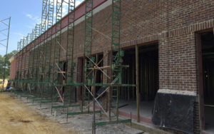 brick masonry under construction framed with scaffolding